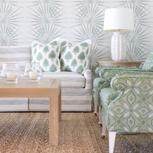 living room with seafoam chairs, pillows, and sofa with natural woven rug