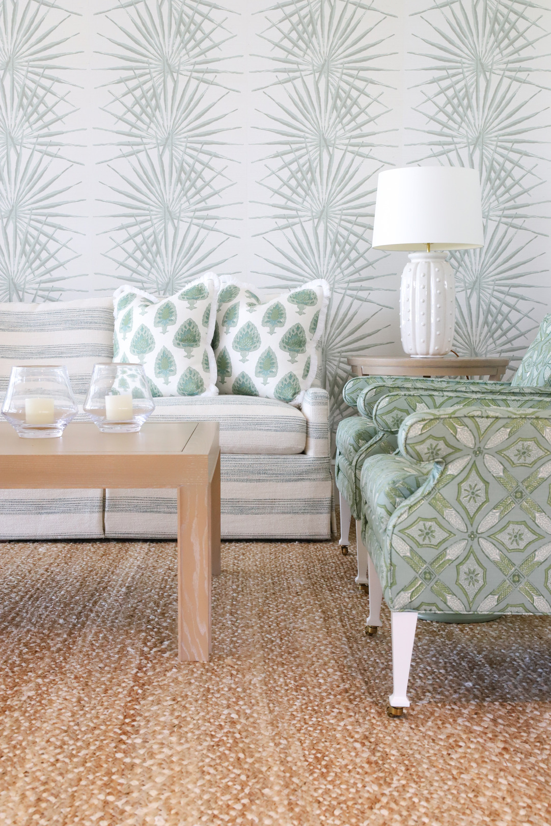 living room with seafoam chairs, pillows, and sofa with natural woven rug