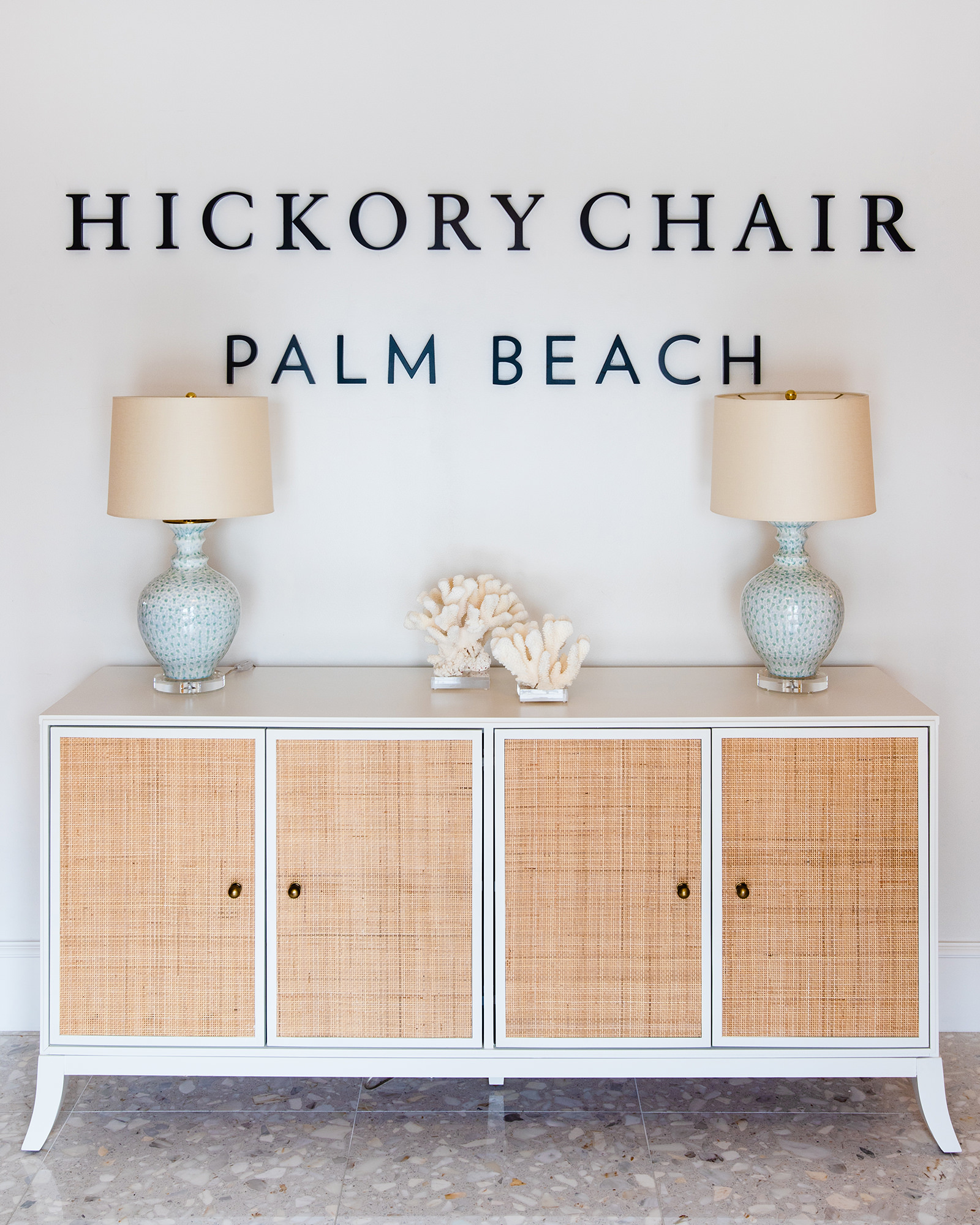 image of hickory chair palm beach entrance white and raffia console with a pair of robin's egg blue lamps and coral decorative accents