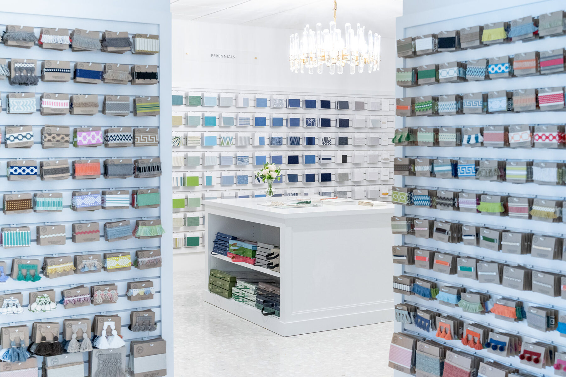 image of showroom colorful sample room with samples organized neatly on walls and an island workspace in the middle